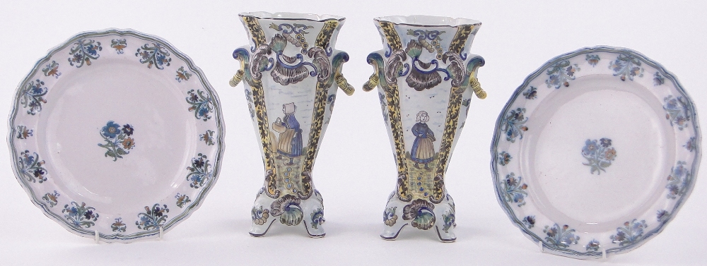 A pair of French Faience glazed pottery vases, with painted country figures, height 10",