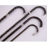 4 Various silver mounted walking canes.