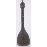 An African carved wood ceremonial hat surmounted by a figure, height 33".