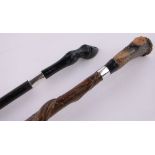 A carved stag horn and silver mounted staff and a silver mounted deer hoof cane, (2).