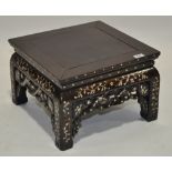 An Oriental rosewood and mother of pearl inlaid jardiniere stand, with a carved and pierced frieze,