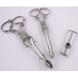 2 Pairs of silver sugar nips and a silver mounted cigar cutter, (3).