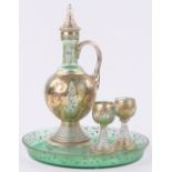 A Venetian painted and gilded green glass decanter with 2 small glasses and matching tray,