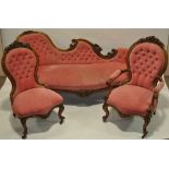 A Victorian carved walnut framed button upholstered salon sofa,