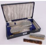 A cased 4-piece silver backed brush and mirror set.