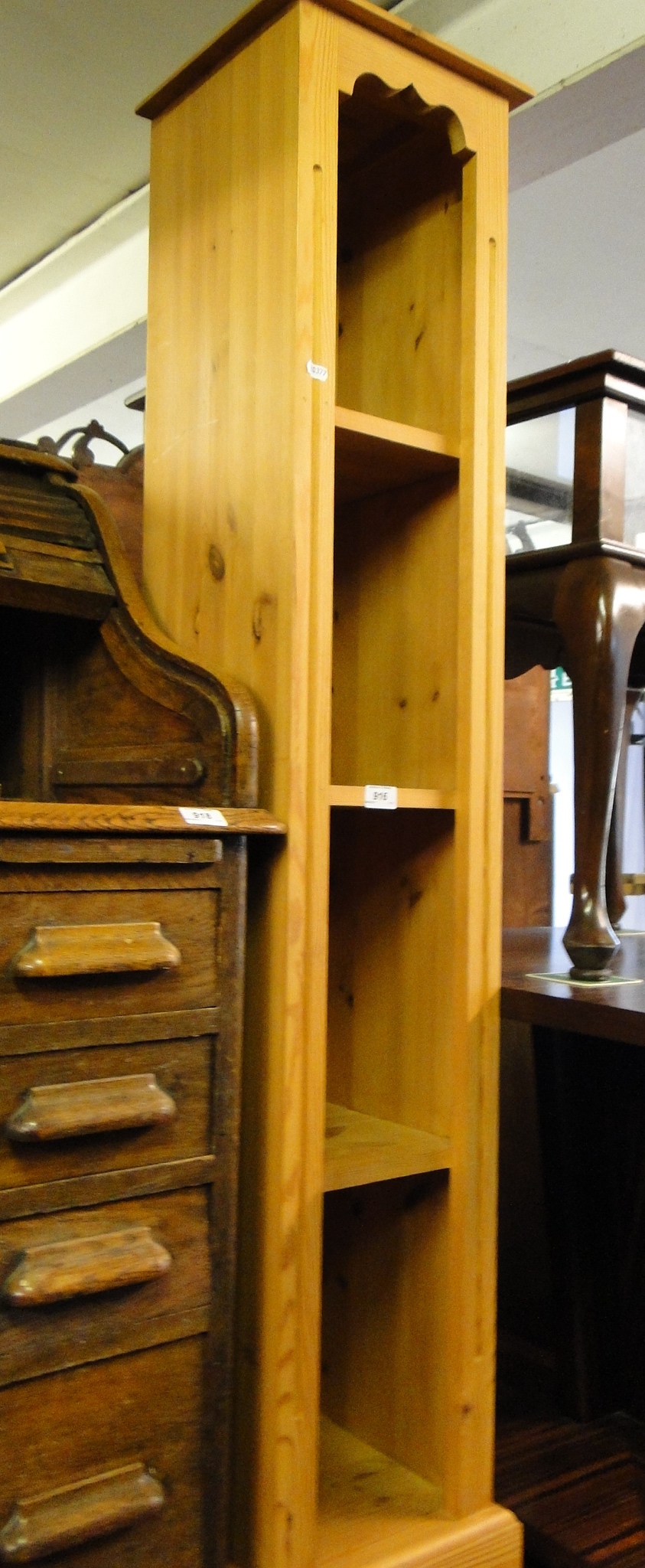 A narrow pine open bookcase.