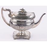 A George III silver urn shaped teapot on pedestal base, of half fluted bulbous form,