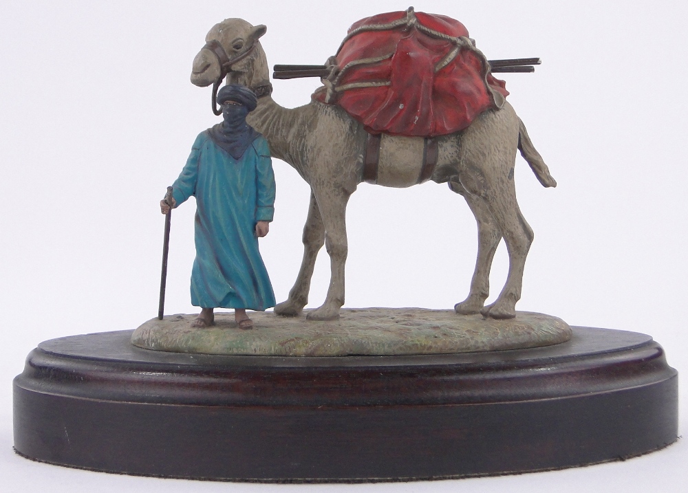 An Austrian cold painted bronze Bedouin tribesman and camel, unmarked, wooden plinth,