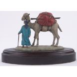 An Austrian cold painted bronze Bedouin tribesman and camel, unmarked, wooden plinth,