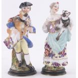 A pair of unusual 19th century continental porcelain perfume bottles in the form of figures