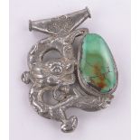 An ornate Tibetan unmarked silver dragon design pendant, set with turquoise panel, length 85mm.
