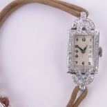 A lady's Swiss platinum and diamond set cocktail wristwatch, case width 13mm.