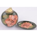 A Moorcroft Hibiscus pattern table lighter and small matching dish, (2).