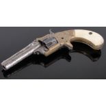 A 19th century American revolver, barrel signed J M Marlin, New Haven, dated 1873 with ivory grips,