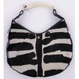 An Yves St. Laurent zebra Mombasa design handbag, with simulated tusk handle.