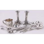 A group of silver items, including pair of candlesticks, table lighter, christening mug, etc.