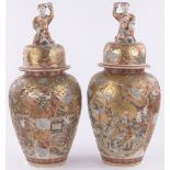 Pair of large Chinese Satsuma porcelain jars and covers, surmounted by figures with fans,
