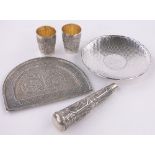 A group of Oriental silver items, including an unmarked relief decorated arched top dish,