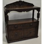 A large Victorian oak buffet, with carved lion mask raised back,