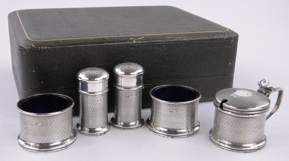 A 5-piece engine turned silver cruet set, with blue glass liners, Birmingham 1928. - Image 2 of 3