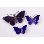 2 Silver and blue enamel butterfly brooches, width 35mm and a purple enamel butterfly brooch, (3).