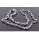 A facet-cut amethyst and crystal necklace.