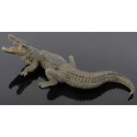 A Vienna cold painted bronze crocodile, the lid opening to reveal a bronze crouching figure,