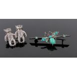 A turquoise and silver butterfly bar brooch, and a silver teddybear brooch, (2).