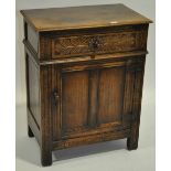 An Ipswich oak design cabinet, with single carved frieze drawer and panelled cupboard under,