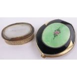 An Art Deco gilt metal and green enamel compact, length 8.5cm.