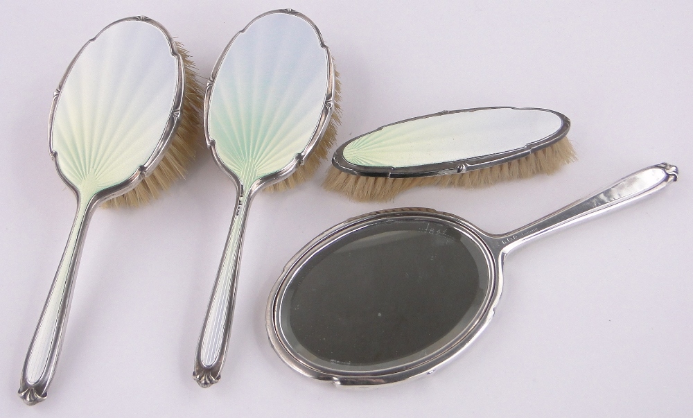 A 4-piece silver and opalescent enamel backed brush and mirror set, Birmingham 1939.