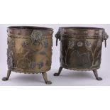 A pair of 19th century copper and brass log bins, with brass lion ring handles and paw feet,
