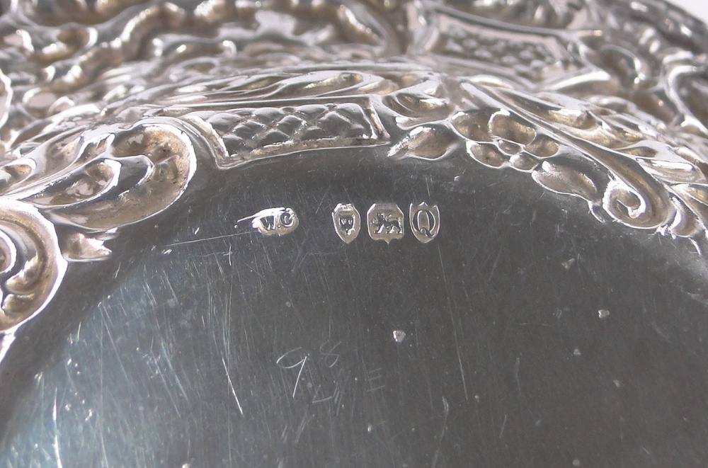 A Victorian oval silver bowl, with relief decorated flowers and scrolls by William Comyns, - Image 3 of 3