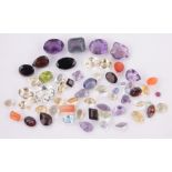 A Collection of unmounted facet-cut gemstones, amehtysts, peridot, sapphire, garnet, etc.