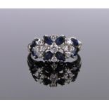 A 14ct white gold sapphire and diamond cluster ring, size N.