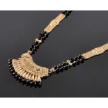 An ornate modern Indian unmarked gold necklace, tests as high carat gold, gross weight 33g.
