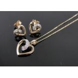 A modern 9ct gold diamond set heart shaped pendant and chain and matching earrings.