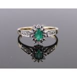 A 9ct gold emerald and diamond cluster ring, setting height 9mm, size N.