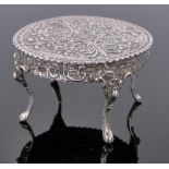 A 19th century Dutch silver dolls house dining table, relief embossed floral designs,