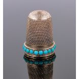 A Victorian unmarked gold thimble, set with a band of turquoise, 5g.
