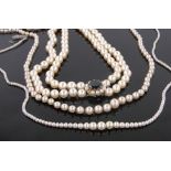 A double string of cultured pearls, with garnet and pearl set 9ct clasp and 2 other pearl necklaces,