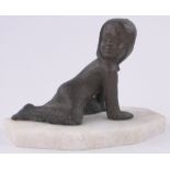 A Russian bronze patinated composition figure of a crawling child,