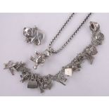 A silver charm bracelet and other silver jewellery.