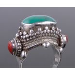 A South East Asian unmarked silver turquoise and coral set ring.