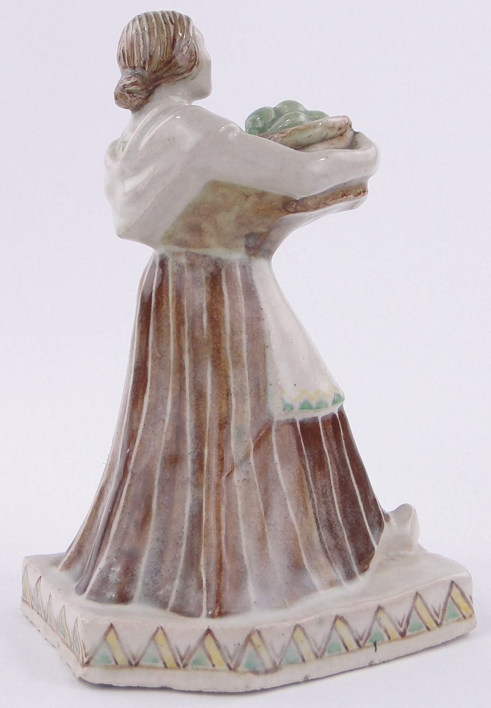 A glazed Studio Pottery figure of a woman carrying a basket of fruit, - Image 2 of 3