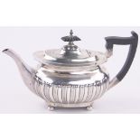 An Edwardian silver teapot of half fluted oval form by Walker & hall Sheffield 1908, 14 oz.