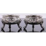 A pair of George II circular cast silver table salts,
