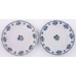 A pair of 18th century French tin glazed chantilly plates, with polychrome floral designs,