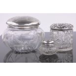 3 Various silver topped toilet jars, largest diameter 11cm.