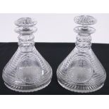 A pair of 19th century step-cut glass ships decanters, with engraved ship design panels,